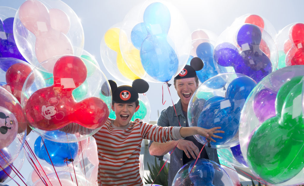 Kid and his dad surrounded by balloons